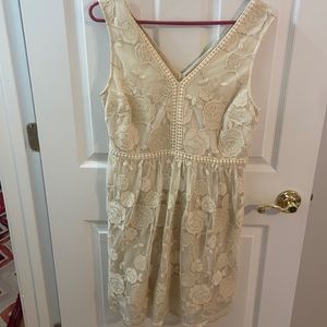 Never been worn. Size L. Cream dress with lace/glitter flower details!